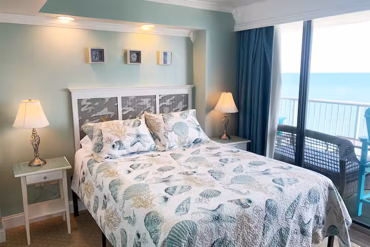 Master bedroom with queen bed, ocean views and direct balcony access